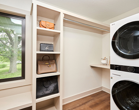 walk-in closet with washer and dry stacked